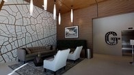This contemporary lounge space makes an immediate impression with its bold, carefully considered design. The most striking feature is a dramatic accent wall adorned with an organic, cracked-earth patterned tile, creating a sculptural focal point that draws the eye upon entry. Contrasting beautifully against this textured wall is a warm wood-slat ceiling and matching vertical paneling, which together lend a refined, natural warmth to the space.

Overhead, a series of elongated cylindrical pendant lights hang at varying heights, casting soft, ambient illumination throughout the room and reinforcing the space's modern aesthetic. A vertical green hedge panel adds a refreshing touch of nature, providing a lively contrast to the surrounding hard surfaces.

The seating arrangement is both stylish and inviting, featuring a sleek, low-profile gray sofa alongside a pair of crisp white accent chairs set atop a decorative area rug. A geometric dark wood coffee table anchors the lounge area, complemented by a polished cylindrical metal waste receptacle nearby. A framed black-and-white photograph mounted on the wood-paneled wall adds a curated, gallery-like quality to the overall ambiance.

The space strikes an effective balance between industrial sophistication and welcoming comfort, making it well-suited as an upscale lobby, lounge, or communal gathering area.