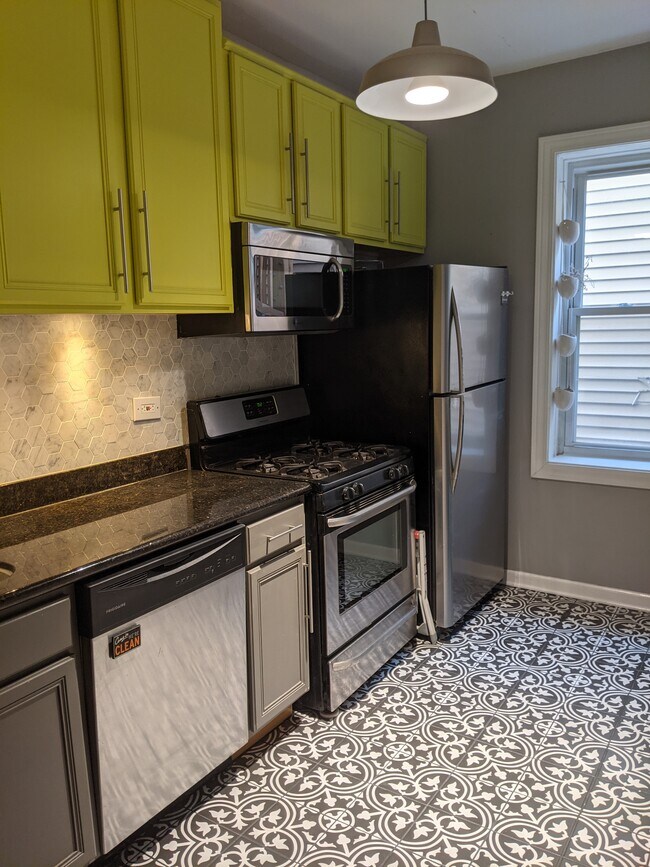 kitchen with stainless appliances including dishwasher - 3560 W Palmer St