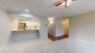 Located at 549 Southwinds Drive in Franklin, TN, this well-appointed 2-bedroom, 3-bathroom single-floor residence offers a comfortable and functional layout. The living room features plush carpeting, crown molding, a ceiling fan with light fixture, a textured ceiling, and a sliding glass door that opens to a private balcony with outdoor views. The open-concept kitchen is equipped with white cabinetry, a peninsula cooktop with a white countertop, a stainless steel refrigerator, a black range, a stainless steel dishwasher, a sink with a modern faucet, and track lighting overhead. A galley-style secondary kitchen view reveals wood-look flooring and ample counter space. Both bedrooms are generously proportioned, featuring soft carpeting, ceiling fans, and natural light from windows with blinds. The spacious primary bedroom includes an adjoining en-suite bathroom. The bathrooms are clean and functional, with at least one featuring a full soaking tub. A dedicated laundry room with washer hookups and overhead shelving adds convenience. Hallways connect the spaces efficiently, and a closet provides additional storage. The overall aesthetic is neutral and move-in ready throughout.