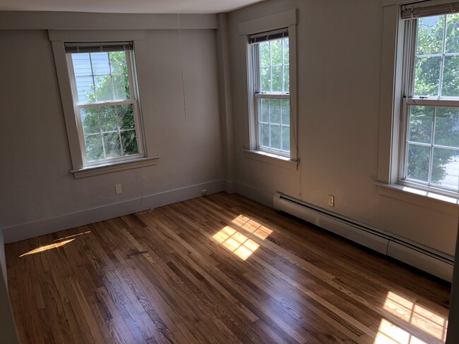 Bedroom 1. Newly refinished hardwood floor. - 33 Pleasant St