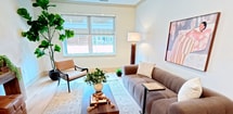 Unit 308 at 983 Michigan Avenue in Buffalo, NY is a well-appointed third-floor, one-bedroom, one-bathroom apartment spanning 590 square feet of efficiently designed living space. Light-toned hardwood flooring flows throughout, tying each room together with a cohesive, contemporary aesthetic. The open kitchen is a standout feature, showcasing custom taupe shaker cabinetry with brass hardware, a herringbone tile backsplash, quartz countertops, stainless steel appliances, and a central island with pendant lighting — ideal for cooking and casual dining. The living room is bright and welcoming, featuring recessed lighting, a large window for natural light, and clean white walls that create an airy atmosphere. The primary bedroom measures 150 square feet and includes a window with exterior views, recessed lighting, and ample space for a full bedroom suite. The bathroom is a striking contrast of styles, featuring classic white penny tile flooring, bold floor-to-ceiling black tile in the walk-in glass shower, a warm wood vanity, and matte black fixtures, delivering a bold yet refined design. Throughout the unit, the neutral color palette, quality finishes, and thoughtful layout make this apartment a functional and stylish urban residence.
