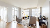 Located at 300 Alexander Ct in Philadelphia, PA, this well-appointed one-bedroom, two-bathroom residence offers a thoughtfully designed single-floor layout. Warm hardwood flooring flows throughout, connecting each space seamlessly.

The open-concept kitchen is a standout feature, equipped with stainless steel appliances, dark espresso cabinetry, a white quartz peninsula with bar seating, a subway tile backsplash, and pendant lighting — all of which open directly into the dining and living areas. The living room is bathed in natural light from oversized windows and offers direct access to a private balcony, providing expansive views of the Philadelphia skyline.

The generously sized primary bedroom captures sweeping city views through a large picture window, creating a bright and airy retreat. A dedicated office space with its own window adds functional versatility to the layout. Two well-organized closets, including a walk-in with custom shelving and hanging systems, provide ample storage.

Both bathrooms are finished with tile flooring and dark vanity cabinetry with white countertops. One bathroom features a full soaking tub with shower combination. A connecting hallway ties all areas of the residence together, contributing to an efficient and comfortable flow throughout the home.