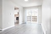 Located at 2421 Chalet Gardens Ct in Fitchburg, WI, this single-floor, 2-bedroom, 1-bathroom unit offers a well-organized layout with a generous living area, dedicated dining room, and thoughtfully updated finishes throughout. Light luxury vinyl plank flooring extends across the entire space, complementing the neutral gray and white color palette that gives each room a clean, contemporary feel.

The open living and dining area is spacious and bright, with large sliding glass doors that invite abundant natural light and provide access to an outdoor area. Baseboard heating runs along the walls throughout the unit. The kitchen is well-appointed with white shaker-style cabinetry, granite-look countertops, a deep double-basin stainless steel sink with a modern pull-down faucet, and a stainless steel dishwasher.

Both bedrooms are comfortably sized with large windows that bring in natural light and offer views of the surrounding landscape. The primary bedroom features a sliding closet with built-in shelving and hanging rods. The second bedroom also includes a window and ample wall space. A hallway connects the main living areas to the bedrooms and full bathroom, which is equipped with a full tub-shower combo and brushed nickel fixtures. A dedicated closet and in-unit laundry hookups add to the unit's practical appeal.