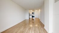 Located at 1971-1975 St. Laurent Blvd in Ottawa, this one-bedroom, one-bathroom unit offers a clean, modern layout across a single floor. Light-toned hardwood flooring runs throughout the space, lending a warm and cohesive feel to every room.

The open living area is bright and airy, flowing directly into a well-appointed kitchen. The kitchen features white cabinetry, stainless steel appliances including a refrigerator and electric range, and a microwave — providing a functional and contemporary cooking space.

The bedroom is a comfortable, well-proportioned room featuring a built-in sliding closet and a window that allows natural light to filter in. A separate image shows a room with a larger window offering an open outdoor view, adding to the unit's sense of brightness and openness.

The bathroom is finished with classic white subway tile surrounding a full soaking tub, complemented by a white vanity with a stone-style countertop, creating a clean and timeless aesthetic.

Throughout the unit, crisp white walls and light hardwood flooring create a neutral, move-in-ready environment. The overall layout is efficient and well-organized, making thoughtful use of the available space to provide comfortable everyday living in a convenient Ottawa location.