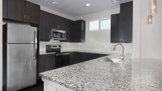 Dining Room and Kitchen with Granite Countertops and Stainless Steel Energy Star Appliances - Venue at the Promenade