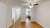 Located at 33 Meeting House Rd in Centerville, Ohio, this two-floor residence offers a practical and well-organized layout across both levels. The main living area is spacious and open, featuring warm hardwood-style flooring and a ceiling fan that adds both function and a classic touch. Large closet panels line one wall, providing generous built-in storage, while the open sightline connects seamlessly to the kitchen and entry hallway.

The kitchen is equipped with rich warm-toned wood cabinetry, light countertops, a double-basin stainless steel sink, and a black electric range with an overhead ventilation hood. A window above the kitchen area allows for natural light to filter in throughout the day.

A standout feature on the lower level is a bright room with French doors that open outward, inviting natural light and offering direct outdoor access. This room's hardwood-style flooring and paneled ceiling give it a distinct, versatile character.

The bedrooms are carpeted for comfort and feature neutral walls with natural light provided by blinds-fitted windows. One bedroom includes two windows, enhancing its brightness. The bathroom includes a full-size soaking tub and shower combination with clean white surrounds and brushed nickel fixtures. Throughout the space, clean white trim and neutral tones create a cohesive, move-in-ready atmosphere.