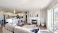 Located at 248 Emerald Blvd in Saukville, WI, this two-bedroom, two-bathroom single-floor home offers a well-designed layout with a cohesive, modern aesthetic throughout. The open-concept living area serves as the heart of the home, anchored by a classic white-mantled fireplace with a tile surround. Large sliding glass doors flood the living room with natural light while providing direct outdoor access and neighborhood views. Warm wood-look flooring runs through the main living areas, adding consistency and warmth.

The kitchen is outfitted with crisp white cabinetry, granite countertops, stainless steel appliances, and a peninsula that transitions seamlessly into the adjacent dining area — ideal for everyday meals and entertaining. A ceiling fan overhead adds comfort to this combined space.

Both bathrooms feature white shaker-style cabinetry, granite countertops, and wood-look flooring, maintaining the home's clean, uniform design. The primary bedroom is generously proportioned, offering plush carpeting, a ceiling fan, and a window with natural light.

The second bedroom provides flexibility as a guest room or home office. A dedicated closet and neutral palette throughout make this home move-in ready. Clean lines, consistent finishes, and a practical single-level floor plan define this well-appointed Saukville residence.