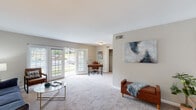 Located at 2419 Wycliff Rd in Raleigh, NC, this single-floor residence offers a well-organized layout designed for comfortable everyday living. The expansive living area is carpeted and filled with natural light, featuring French doors that open to outdoor views and provide a bright, airy atmosphere. A dedicated workspace area with closet storage sits just off the main living space, offering functional flexibility. Adjacent to the living area, a second lounge zone provides additional room for relaxing or entertaining.

The galley-style kitchen is efficiently designed with white cabinetry, stone-look countertops, a stainless steel sink, and wood-look flooring. Black appliances, including a full-size refrigerator, complement the clean, classic aesthetic.

The residence includes two well-proportioned bedrooms, both carpeted and filled with natural light from large windows. Each bedroom offers ample space for furnishings and easy access to closet storage. Two bathrooms serve the home, each featuring white vanity cabinetry, stone-look countertops, and wood-look flooring, maintaining a consistent and clean design language throughout.

Overall, the space presents a neutral, welcoming palette with consistent finishes across all rooms, making it a practical and comfortable home in the heart of Raleigh.