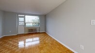 Located at 20 Trudelle Street in Toronto's Scarborough neighbourhood, this 2-bedroom, 1-bathroom unit offers a practical and well-organized layout across a single floor. Warm-toned parquet flooring flows consistently throughout the living areas and both bedrooms, lending the space a classic and cohesive character.

The living room is a comfortable, open area filled with natural light through a wide picture window. A radiator beneath the window provides in-suite heating, and the polished parquet floors reflect the incoming light, enhancing the sense of brightness and space.

The kitchen has been updated with white cabinetry, stone-finish countertops, a neutral tile backsplash, and ample storage through both upper and lower cabinets — offering a clean, functional cooking environment.

Both bedrooms are well-proportioned and finished with the same parquet flooring and neutral grey walls. The primary bedroom includes a built-in sliding door closet, while the second bedroom features its own window with views of surrounding greenery and a radiator for added comfort.

The bathroom is finished in white horizontal tile, featuring a full soaker tub with shower, a vanity with under-cabinet storage, and a mirror.

A private balcony extends the living space outdoors, overlooking a quiet, tree-lined street with open neighbourhood views.