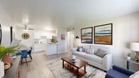 This thoughtfully laid-out one-bedroom, one-bathroom unit offers a practical and comfortable single-floor living experience. The open-concept main area seamlessly connects the living room, dining area, and kitchen, creating a cohesive and functional space. Light wood-style flooring flows throughout the main living areas, complemented by neutral wall tones that enhance the bright, airy atmosphere.

The living room features a large window fitted with blinds, allowing generous natural light to fill the space. The kitchen is equipped with white shaker-style cabinetry, light countertops, stainless steel appliances including a refrigerator, dishwasher, and range, and a peninsula that provides additional workspace and casual seating. Adjacent to the kitchen, the dining area includes a ceiling fan and offers a defined space for everyday meals.

The bedroom is a comfortable retreat with carpeted flooring, a window overlooking the outdoors, and ample room for a full-size bed and furnishings. A dedicated closet and a hallway provide practical storage solutions. The full bathroom includes a shower/tub combination. Throughout the unit, the clean, modern design and efficient use of space make it a well-rounded and functional residence.