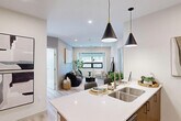 Located in the heart of downtown Edmonton at 101A Avenue, this well-appointed 2-bedroom, 2-bathroom unit offers a thoughtfully designed single-floor layout. The open-concept living and kitchen area serves as the centerpiece of the home, where light wood-toned flooring flows seamlessly throughout. The kitchen is equipped with stainless steel appliances, two-tone cabinetry in white and warm brown, a gas range, and a waterfall-edge island with bar seating, illuminated by striking black cone pendant lights. The living room is bright and welcoming, featuring large windows that frame views of the Edmonton skyline and fill the space with natural light. Both bedrooms are comfortably proportioned, with the primary bedroom benefiting from expansive floor-to-ceiling windows offering impressive city views. Three closets provide ample storage throughout the unit. The two bathrooms are finished with wood-look tile, warm cabinetry, and white countertops — one featuring a glass-enclosed shower, the other a full soaker tub with shower. Additional conveniences include in-unit laundry and a well-organized hallway entry. The overall aesthetic is clean, modern, and cohesive, making this an ideal urban residence.