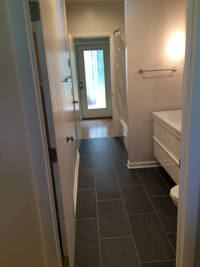 View from laundry through bathroom to backdoor. - 706 Tyler Road