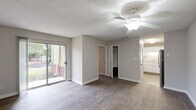 Located at 2310 W Cameo Ln in Knightdale, NC, this single-floor, one-bedroom, one-bathroom residence offers a thoughtfully designed layout with consistent wood-look flooring and neutral tones throughout. The living room is a bright, open space anchored by a ceiling fan and a sliding glass door that leads to a private patio, flooding the room with natural light and offering pleasant outdoor views of the surrounding greenery. A textured ceiling adds subtle architectural character throughout the home. The kitchen is efficiently designed with crisp white shaker-style cabinetry, granite-look countertops, a double-basin sink, and stainless steel appliances, including a refrigerator and dishwasher. A louvered bifold door provides a clean separation between the kitchen and the main living area. The spacious bedroom features a large window that brings in natural light, two dedicated closets — one of which is a walk-in — offering generous storage. The bathroom is clean and functional, appointed with a white vanity, solid countertop, and a well-lit mirror. With its move-in-ready finishes and practical floor plan, this residence delivers a comfortable and efficient living experience in Knightdale.