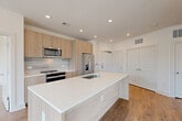 Located at 285 Mayson Ave NE in Atlanta, GA, this contemporary 3-bedroom, 2-bathroom residence offers a thoughtfully designed single-floor layout with modern finishes throughout. The open-concept living area seamlessly connects the kitchen, dining, and living spaces, all finished with warm hardwood-style flooring and recessed lighting. The kitchen is a standout feature, showcasing light wood cabinetry, a subway tile backsplash, stainless steel appliances, and a large center island with a quartz countertop and undermount sink — ideal for both cooking and entertaining. The living room is bright and airy, with large sliding glass doors opening to a private balcony offering open outdoor views. The primary bedroom continues the theme of natural light, featuring expansive floor-to-ceiling sliding doors and a ceiling fan. The primary bathroom is elegantly appointed with marble-style tile flooring, a glass-enclosed shower, a soaking tub, and a floating double vanity. Additional bedrooms are well-sized with hardwood-style flooring and ample closet space, supported by four closets total — including walk-in options with built-in wire shelving. A dedicated laundry area and hallway complete the functional layout of this clean, modern home.