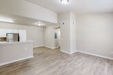 Located at 918 Paul St in Saraland, Alabama, this single-floor residence offers a well-designed, open-concept layout with a clean, neutral aesthetic throughout. Light-toned luxury vinyl plank flooring flows seamlessly across the main living areas, complementing the warm beige walls and white trim.

The kitchen is a standout feature, outfitted with crisp white shaker-style cabinetry, marble-look countertops, and a tasteful mosaic tile backsplash. Stainless steel appliances — including a refrigerator, electric range, and dishwasher — add a modern touch, while a peninsula with a double sink provides both additional prep space and a natural division between the kitchen and living area. Generous cabinet storage, including a tall pantry unit, enhances functionality.

The open living area is bright and spacious, benefiting from a large window that invites natural light. Vaulted ceiling details in portions of the space add architectural interest and a sense of openness.

The bedroom is carpeted for comfort and includes a ceiling fan, built-in shelving, and direct access to a well-appointed en-suite bathroom. This primary bathroom features an L-shaped vanity with marble-look countertops, white cabinetry, and a large mirror with Hollywood-style lighting. A second bathroom includes a tiled tub-shower combination and overhead cabinet storage.
