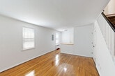 Located at 126 Litton Ct in Groton, Connecticut, this two-story, 2-bedroom, 1-bathroom home offers a practical and well-organized layout spread evenly across two floors. The main level features a bright living room with polished hardwood floors, large windows that invite natural light, and a radiator heating system. The adjacent dining room flows naturally into a compact, well-equipped kitchen showcasing rich dark wood cabinetry, a herringbone-patterned tile floor, a stone mosaic backsplash, and stainless steel appliances. A dedicated laundry area and entrance round out the ground floor. Upstairs, the two bedrooms are generously proportioned for the home's scale, each featuring gleaming hardwood floors, wide windows with views of the surrounding greenery, and radiant heating. The primary bedroom is a comfortable size with multiple closets for storage. The full bathroom is neatly finished with white subway tile, a tub-shower combination, modern brushed nickel fixtures, and a wood-framed mirror with an integrated vanity. Outdoor space includes a private patio surrounded by mature trees, offering a peaceful, secluded setting. Three closets throughout the home ensure ample storage.