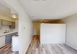 Located at 73 Brookdale Dr in Merced, California, this efficiently designed one-bedroom, one-bathroom unit offers a practical single-floor layout. Light wood-style laminate flooring runs throughout, creating a cohesive and clean aesthetic across all rooms.

The living area connects directly to the kitchen, which features gray lower and upper cabinetry, a white double-basin sink, a dishwasher, and a range. The layout makes efficient use of the available space while providing essential appliances and storage.

The bedroom is the largest room in the unit, offering generous proportions relative to the overall footprint. It includes a built-in sliding-door closet for storage and is equipped with a ceiling fan with light fixture. A large window allows natural light to fill the space, contributing to an open, airy feel.

The bathroom is straightforward and functional, featuring a shower-tub combination with a curtain rod, a toilet, and a vanity with a countertop sink. Wood-style flooring continues into this room, maintaining visual consistency.

Throughout the unit, textured ceilings and neutral beige and white wall tones provide a simple, clean backdrop. The floor plan, visible in the 3D overview, shows a well-organized, compact arrangement suited for individual or couple occupancy.