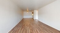 This 680 square foot apartment in Summit West offers a thoughtful layout maximizing space and functionality. The open-plan living area features wood-look flooring and a large window, providing natural light and city views. The kitchen, though compact, is well-equipped with wooden cabinetry, white appliances, and a convenient pass-through to the living area.

The bedroom, measuring 160 square feet, includes a built-in closet and ceiling fan for comfort. The bathroom showcases clean, white tiling and a full-size bathtub. A standout feature is the in-unit laundry area with full-size washer and dryer, uncommon in apartments of this size.

Throughout the space, neutral walls and modern finishes create a bright, contemporary ambiance. Ceiling fans in both the living area and bedroom provide additional comfort. The apartment's efficient design incorporates ample storage solutions, including closets and kitchen cabinets, making it ideal for those seeking a low-maintenance yet comfortable living space in an urban setting.