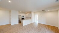 Located at 585 West Dr in Georgetown, DE, this thoughtfully designed two-bedroom, two-bathroom residence offers a clean, modern aesthetic across a single floor. Light wood-look flooring flows seamlessly throughout every room, creating a cohesive and bright atmosphere. The open-concept kitchen and living area serves as the heart of the home, showcasing white shaker-style upper cabinets, gray lower cabinetry, a subway tile backsplash, a peninsula with a light countertop, and stainless steel appliances including a refrigerator, range, and microwave. Recessed lighting illuminates the space, which connects naturally to a spacious living area featuring a glass panel door leading to the outdoors. Both bedrooms are well-proportioned and filled with natural light from large windows dressed with blinds, and each is equipped with a ceiling fan. The primary bedroom offers a generous layout with ample closet space. The two bathrooms are finished in a clean, neutral palette, with one featuring a shaker-style vanity, a tub/shower combo, and wood-look tile flooring. Additional highlights include a dedicated laundry area, multiple closets for storage, and a welcoming hallway entry. The overall ambiance is fresh, modern, and move-in ready.