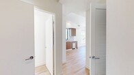 Located on Santa Monica Boulevard in the heart of West Los Angeles, this modern 1-bedroom, 1-bathroom residence offers a thoughtfully designed layout across a single floor. Light wood flooring flows throughout, lending warmth and continuity to every room.

The open-plan kitchen and living area serves as the heart of the home. The kitchen is outfitted with rich walnut-toned cabinetry, white quartz countertops, a tiled backsplash, stainless steel appliances including a refrigerator, range, built-in microwave, and dishwasher, and a window that brings in natural light. The adjacent living area features a large, unobstructed accent wall and recessed lighting, offering flexibility for a variety of furniture arrangements.

The bedroom is a bright, comfortable retreat with floor-to-ceiling windows framing views of the Los Angeles skyline and palm tree-lined streets. Mirrored sliding closet doors enhance the sense of space. In-unit stacked laundry is conveniently accessible directly from the bedroom.

The bathroom features a clean, contemporary design with a backlit vanity mirror, white quartz countertop, taupe cabinetry, and a full tiled tub-shower combination. A hallway connects all areas of the residence, completing this efficiently designed urban home.