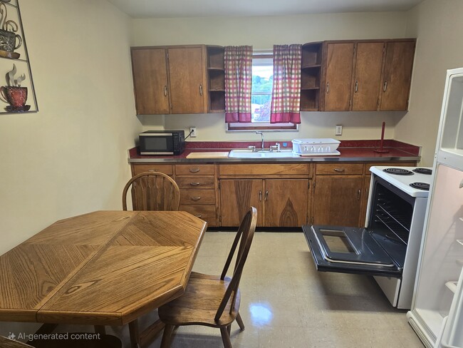 LARGE KITCHEN... SELF-CLEANING STOVE....FULL SIZE REFRIGERATOR WITH PLENTY OF CABINETS! - 1216 University Ave