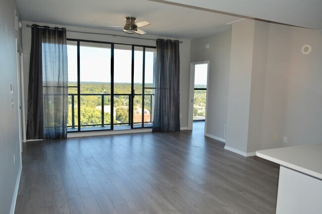 Living Room with Floor to Ceiling Glass Doors - 226 5th Ave N