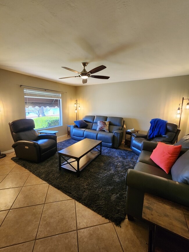 Living room view of lake with reclining Lazy-e-boy seating, Smart Roku TV and great lake views. - 5050 N 81st St