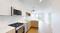 Located at 4135 Park Blvd in San Diego's vibrant 92103 neighborhood, this modern one-bedroom, two-bathroom unit offers a thoughtfully designed open-concept layout. Light wood flooring flows throughout, complementing the clean white walls and contemporary aesthetic.

The kitchen and living area share an open, connected space that maximizes functionality. The kitchen is well-appointed with stainless steel appliances — including a gas range, built-in microwave, and dishwasher — paired with warm wood cabinetry, white quartz countertops, and a classic subway tile backsplash. A pendant light anchors the kitchen, while a sliding glass door fills the living area with natural light and provides direct access to a private balcony with open city views.

The bedroom is a bright, cozy retreat featuring a large window overlooking the balcony and surrounding neighborhood. A dedicated closet adds practical storage.

Both bathrooms showcase modern finishes, including floating white vanities with brushed gold fixtures, hexagonal mosaic tile flooring, and a glass-enclosed walk-in shower with floor-to-ceiling vertical white tile. The overall design is clean, minimal, and cohesive — ideal for those seeking contemporary urban living in San Diego.
