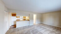 Located at 424 Cedar Glen Dr in Fort Wayne, Indiana, this single-floor unit offers a practical and well-organized layout designed to maximize every square foot. The open-concept living area flows seamlessly into the kitchen, which features a peninsula-style breakfast bar that doubles as a room divider. The kitchen is equipped with warm honey-toned wood cabinetry, granite-style countertops, a stainless steel sink, and white appliances including a refrigerator, electric coil range, and over-the-range microwave. Durable wood-look flooring runs throughout the kitchen, while the living and bedroom areas are finished with plush neutral carpeting that adds warmth underfoot. The bedroom is a bright and comfortable space with a large window that invites natural light and outdoor views, complemented by a built-in closet with bifold doors for ample storage. The bathroom includes a full shower-tub combo with chrome fixtures and a clean, white finish. Additional practical amenities include a dedicated laundry area and a utility room. Neutral warm-beige walls and white ceilings throughout create a cohesive, light, and airy ambiance, making this a functional and comfortable space.