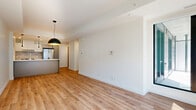 Located at 600 Mountaineer Pvt in Ottawa, this modern 2-bedroom, 2-bathroom unit offers a well-designed single-floor layout with a clean, contemporary aesthetic throughout. Light-toned hardwood flooring flows seamlessly through the open-concept living, dining, and kitchen area, creating a cohesive and airy feel. The kitchen is a standout feature, equipped with stainless steel appliances including a full-size refrigerator and stove, sleek grey cabinetry, a white quartz waterfall island with an undermount sink, and a trio of stylish black pendant lights overhead. The living area benefits from a large sliding glass door that opens to a balcony, inviting natural light and outdoor views of the surrounding urban development. Both bedrooms are bright and well-proportioned, each featuring large black-framed windows that frame views of the neighbourhood. Three closets provide ample storage throughout the unit. The two bathrooms are finished in a crisp white palette — one features a walk-in shower with grey stone-look tile flooring, while the second includes a soaker tub with a glass panel surround. A dedicated laundry area and utility room add practical convenience. The overall ambiance is fresh, bright, and move-in ready.