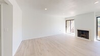 Located at 520 E Murray Canyon Drive in Palm Springs, California, this one-bedroom, two-bathroom residence offers a bright and airy single-floor layout filled with natural light. The open-concept living and dining area features light wood flooring, recessed lighting, a classic fireplace, and two sliding glass doors that lead to separate balconies, creating a seamless indoor-outdoor connection. A wet bar with white cabinetry and a mirror backsplash bridges the living space with the rest of the home. The kitchen is thoughtfully equipped with white cabinetry, granite-look countertops, stainless steel appliances including a refrigerator, range, and microwave, and tile flooring. Ample built-in cabinetry provides generous storage throughout. The spacious primary bedroom includes a ceiling fan, light wood flooring, a sliding glass door to a private balcony, and floor-to-ceiling mirrored sliding closet doors. The primary bathroom features a long vanity, tub/shower combo, and tile flooring. A second bathroom is conveniently combined with laundry facilities. Two additional closets and a hallway complete this well-organized floor plan, making this Palm Springs residence a comfortable and functional desert retreat.