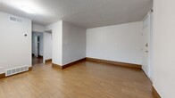 Located at 1386 Court Ave in Memphis, TN, this efficiently designed one-bedroom, one-bathroom unit offers a well-organized single-floor layout. Throughout the space, warm wood-style flooring and crisp white walls create a clean, cohesive aesthetic, complemented by textured ceilings and rich dark baseboards that add a subtle contrast.

The living room is an open, bright area with a window that allows natural light to fill the space, creating an inviting atmosphere. The kitchen is thoughtfully appointed with white cabinetry, light granite-style countertops, a stone tile backsplash, stainless steel appliances including a full-size refrigerator and range, and a double-basin sink — maximizing both function and style within a compact footprint.

The bedroom is a comfortable, well-proportioned room with a window overlooking the exterior and access to a dedicated closet. The bathroom features a full tub and shower combo finished with large-format, stone-patterned wall tiles in warm beige and gray tones, offering a polished look. Doors from the bedroom open conveniently to both the bathroom and kitchen, promoting an efficient flow throughout the unit. This well-maintained space is an excellent option for those seeking straightforward, functional living in Memphis.
