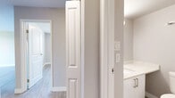 Located at 1655 Haro St in Vancouver's desirable West End neighbourhood, this one-bedroom, one-bathroom unit offers a thoughtfully designed layout with modern updates throughout. Light wood laminate flooring runs continuously across the living spaces, contributing to a bright and cohesive feel.

The living area is generously proportioned and benefits from large floor-to-ceiling sliding glass doors that open to a balcony, filling the room with natural light and framing views of the surrounding Vancouver skyline and North Shore mountains. A baseboard heating system runs along the exterior wall.

The galley-style kitchen is efficiently designed and well-equipped, featuring white cabinetry, light stone countertops, a grey subway tile backsplash, stainless steel appliances including a refrigerator and range, an integrated microwave, and an undermount sink — all finished with brushed nickel hardware.

The bedroom is a comfortable size, complete with a built-in closet with bifold doors and a window overlooking the city skyline, allowing for ample natural light. The hallway connects to additional storage space.

The bathroom is clean and modern, featuring light tile flooring, a white vanity with stone countertop, brushed nickel fixtures, and panel-style doors with classic raised moulding detailing throughout the unit, adding a refined architectural touch.