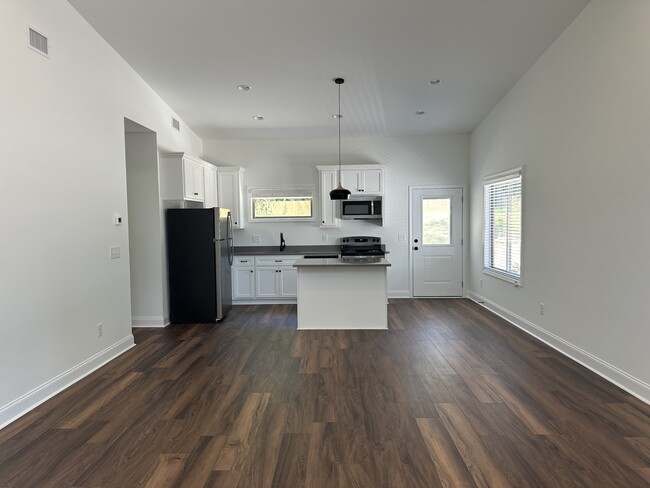 Open concept living room and kitchen. View from inside front door. - 1595 Auburn St