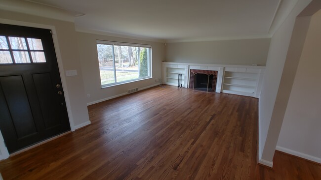 Large living room with lots of natural light, fireplace and built in storage - 6934 Winding Way