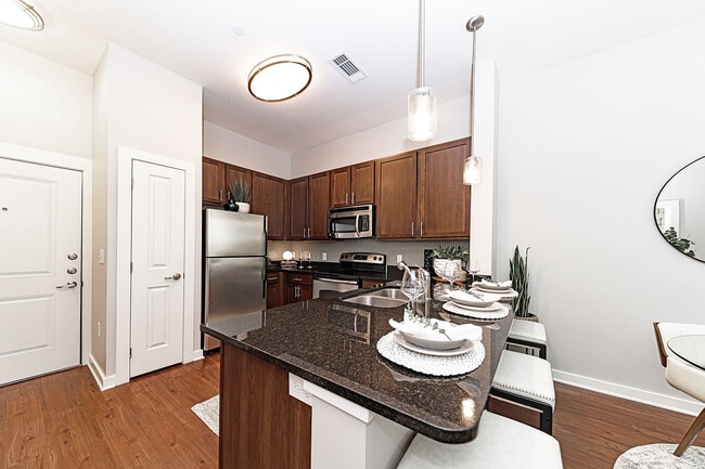 Kitchen with granite counters and stainless appliances - Pine Street Flats