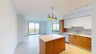 Located in Miami's vibrant urban core, this well-designed 3-bedroom, 2-bathroom residence offers a clean, contemporary aesthetic defined by bright white walls, large-format light tile flooring, and an abundance of natural light throughout. The open-concept kitchen and living area serves as the heart of the home, featuring a central island with a crisp white quartz countertop, warm wood-toned lower cabinetry contrasted by sleek white upper cabinets, and a full suite of stainless steel appliances including a refrigerator, range, microwave, and dishwasher. A modern pendant light fixture anchors the space, while floor-to-ceiling sliding glass doors open to a balcony, flooding the living area with Miami sunshine and city views. Each of the three bedrooms is finished with the same light tile flooring and crisp white walls, offering a clean, versatile canvas. Several bedrooms feature large sliding glass doors or windows that frame views of the waterway and surrounding cityscape. The two hallways connect the rooms with a bright, airy flow, complemented by recessed lighting. The bathrooms are tastefully appointed with white tile surrounds, wood-accented vanities, white quartz countertops, and a bathtub-shower combination. A dedicated closet adds practical storage to complete this polished Miami residence.
