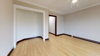 This 630 square foot apartment in Milwaukee, Wisconsin, offers a well-designed living space on a single floor. The property features one bedroom, measuring 140 square feet, and one bathroom. The layout includes a living room, kitchen, and two hallways, creating an efficient use of space.

The apartment showcases beautiful hardwood floors throughout, adding warmth and character to each room. Large windows in the living area and bedroom provide ample natural light, creating a bright and inviting atmosphere. The living room is spacious, with clean white walls and dark wood trim around the windows and baseboards, offering a classic aesthetic.

The kitchen is a highlight of the property, boasting modern white cabinetry and sleek stainless steel appliances. The granite countertops add a touch of luxury, while a peninsular counter with an overhang creates additional workspace and a casual dining area. The kitchen's open design allows for easy interaction with the living space.

The bathroom features white tiled walls and a pedestal sink, maintaining a clean and classic look. A window in the bathroom provides natural light and ventilation. The bathtub is equipped with a shower and a striped curtain, adding a subtle decorative element.

The bedroom, while compact, offers enough space for essential furniture. Like the rest of the apartment, it benefits from hardwood flooring and a large window, ensuring a bright and comfortable sleeping area.

Overall, this apartment combines modern amenities with classic architectural elements, creating a cozy yet functional living space in the heart of Milwaukee.