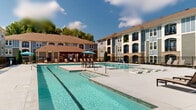 Located at 141 Stobhill Ln in Fuquay-Varina, North Carolina, this outdoor amenity area is a centerpiece of the residential community, offering a resort-style experience within a well-maintained setting. The space is defined by a generously sized swimming pool with clear, blue water, complemented by a broad concrete sundeck that surrounds it on multiple sides. The deck is furnished with rows of comfortable lounge chairs, providing ample space for relaxation and sunbathing under the open North Carolina sky. A covered pergola structure on one end of the pool area offers a shaded retreat, while umbrella-shaded seating arrangements are positioned poolside for additional comfort. The pool area is enclosed by a black iron fence, maintaining a sense of security while preserving open sightlines to the surrounding landscape. The multi-story residential buildings flanking the pool feature a contemporary architectural design, blending brick accents, siding panels, and large windows with private balconies that overlook the amenity area. Mature trees frame the perimeter, adding natural greenery to the environment. The overall ambiance is bright, open, and inviting, with abundant natural light and well-maintained landscaping contributing to an appealing outdoor living experience across two floors of residential use.