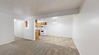 This well-designed single-story residence in Cottonwood Heights offers 1090 square feet of living space, including three bedrooms and two bathrooms. The home's layout is thoughtfully planned, with a spacious primary bedroom measuring 210 square feet. The open-concept design combines the kitchen and living room, creating a cohesive and functional space for daily life and entertaining.

The kitchen features wooden cabinetry, granite countertops, and white appliances, with ample storage and preparation space. Throughout the home, neutral-toned carpeting provides comfort and warmth, while the bathrooms and kitchen showcase durable tile flooring. The bathrooms are equipped with modern fixtures, including combination shower-tub units and single vanities.

Large windows in the bedrooms allow natural light to flood the spaces, enhancing the sense of openness. The home's bright, white walls create a clean and fresh aesthetic throughout. Sliding glass doors in the living area provide access to the outdoor space, seamlessly connecting indoor and outdoor living. The property also includes a utility room for added convenience.

With its practical layout and comfortable finishes, this Cottonwood Heights home offers a welcoming environment for a variety of lifestyles.