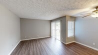Located at 3099 Kirklevington Drive in Lexington, Kentucky, this single-floor, 2-bedroom, 2-bathroom residence offers a practical and comfortable layout. The living area features durable hardwood-style flooring, neutral gray walls, and a textured ceiling, creating a clean and inviting atmosphere. A sliding glass door floods the space with natural light and provides outdoor access, complemented by additional windows fitted with white blinds.

The galley-style kitchen is equipped with warm honey-toned wood cabinetry, dark granite-style countertops, a stainless steel sink, and matching appliances, offering ample storage and counter space for everyday cooking.

Both bedrooms feature plush carpeting, sliding closet doors for built-in storage, and windows that invite natural light. The primary bedroom is a comfortable, well-proportioned retreat, while the second bedroom offers similar finishes and functionality, connected via a hallway.

The two bathrooms are a standout feature, each showcasing a soaking tub and shower combination adorned with large-format marble-look tile surrounds and brushed nickel fixtures. One bathroom also includes a vanity with a wood cabinet base and a wide mirror. A connecting hallway ties all spaces together efficiently throughout the home.