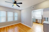 Located in Chicago's Rogers Park neighborhood, this well-appointed 3-bedroom, 2-bathroom single-floor residence offers a thoughtfully designed layout with consistent, quality finishes throughout. Warm hardwood floors extend across every room, complemented by soft gray walls and crisp white trim that create a clean, modern aesthetic.

The two living areas provide generous, flexible space for lounging or entertaining, each outfitted with ceiling fans and recessed lighting. Wide doorway openings between rooms enhance the sense of openness and flow. The kitchen features two-tone cabinetry — white upper cabinets paired with gray lower cabinets — along with a subway tile backsplash, stainless steel appliances including a dishwasher and refrigerator, and a window that brings in natural light.

Each of the three bedrooms is a comfortable size, with the primary bedroom offering notably generous proportions. All bedrooms include ceiling fans and ample closet space — three closets are distributed throughout the unit. The bathrooms are finished with classic white subway tile in the tub surround, a clean vanity, and a window for natural ventilation.

Multiple hallways connect the rooms efficiently, and the overall layout balances privacy with livability — making this a practical and attractive home in a vibrant Chicago neighborhood.