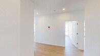 Located at 200 Garden St in South Burlington, Vermont, this thoughtfully designed 3-bedroom, 2-bathroom residence offers a bright and contemporary living experience across a single floor. Light hardwood flooring flows throughout, complementing the clean white walls and modern aesthetic found in every room.

The open-concept kitchen and living area serves as the heart of the home, featuring a central island with a built-in sink, white shaker-style cabinetry, light stone countertops, and a full suite of stainless steel appliances including a refrigerator, range, and over-the-range microwave. Recessed lighting and large windows allow natural light to fill the space.

The bedrooms are generously proportioned, each offering large windows with views of the surrounding South Burlington community. The primary bedroom is particularly spacious, and several rooms are equipped with wall-mounted mini-split units for individual climate control, alongside baseboard heating. A dedicated walk-in closet with built-in wire shelving provides ample storage.

Both bathrooms are finished in a clean, modern style with white vanities, large mirrors, light wood-tone flooring, and tub/shower combinations. The overall ambiance of this residence is bright, clean, and contemporary, making it a comfortable and functional home.