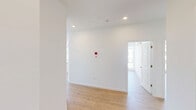 Located at 200 Garden St in South Burlington, Vermont, this thoughtfully designed 3-bedroom, 2-bathroom residence offers a bright and contemporary living experience across a single floor. Light hardwood flooring flows throughout, complementing the clean white walls and modern aesthetic found in every room.

The open-concept kitchen and living area serves as the heart of the home, featuring a central island with a built-in sink, white shaker-style cabinetry, light stone countertops, and a full suite of stainless steel appliances including a refrigerator, range, and over-the-range microwave. Recessed lighting and large windows allow natural light to fill the space.

The bedrooms are generously proportioned, each offering large windows with views of the surrounding South Burlington community. The primary bedroom is particularly spacious, and several rooms are equipped with wall-mounted mini-split units for individual climate control, alongside baseboard heating. A dedicated walk-in closet with built-in wire shelving provides ample storage.

Both bathrooms are finished in a clean, modern style with white vanities, large mirrors, light wood-tone flooring, and tub/shower combinations. The overall ambiance of this residence is bright, clean, and contemporary, making it a comfortable and functional home.