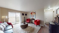 Located at 2000 McKelvey Hill Dr in Maryland Heights, Missouri, this single-floor residence offers a thoughtfully laid-out living space designed for comfort and functionality. The living room serves as the heart of the home, featuring neutral-toned walls, plush carpeting, and a sliding glass door that opens to a private patio, allowing natural light to fill the space and providing a seamless indoor-outdoor connection. The galley-style kitchen is efficiently designed with wood-toned cabinetry, a black appliance suite including a range and dishwasher, a stainless steel sink, and durable hardwood-style flooring that extends into the adjacent dining area. The dining space accommodates a full dining set and is accented by a ceiling fan overhead. The bedroom is generously sized with soft carpeting, a large window dressed with blinds that invite natural light, and ample wall space. The full bathroom features a tub-shower combination, a vanity with an extended countertop, a large mirror, and hardwood-style flooring, completing the practical layout of the home. Throughout the residence, warm neutral tones and consistent finishes create a cohesive and inviting ambiance.