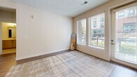 Located at 2700 E College Ave in Decatur, GA, this well-appointed apartment offers 2 bedrooms, 2 bathrooms, and a thoughtfully designed single-floor layout. The open-concept living, dining, and kitchen area forms the heart of the home, anchored by a central kitchen island with a built-in sink and elegant pendant lighting. The kitchen is outfitted with stainless steel appliances, light wood-toned cabinetry, a decorative tile backsplash, and generous counter space — all finished with durable hardwood-style flooring. The living area extends naturally toward large windows and a patio door, filling the space with natural light and providing outdoor access. Both bedrooms feature plush carpeting and windows with exterior views. The spacious primary bedroom includes a well-organized walk-in closet with wire shelving. Two full bathrooms feature large-format tile flooring, modern vanities with white countertops, and clean, contemporary finishes — one with a soaking tub and another with a shower. Three closets throughout provide ample storage, and a dedicated in-unit laundry area adds everyday convenience. The overall aesthetic is clean, modern, and neutral, offering a bright and welcoming living environment.