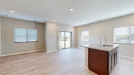 Located at 4750 Innovation Dr. in Lincoln, Nebraska, this single-floor, 2-bedroom, 2-bathroom unit offers a thoughtfully designed open-concept layout. The combined kitchen and living area serves as the heart of the home, featuring light hardwood-style flooring, recessed lighting, and neutral-toned walls that create a bright, welcoming atmosphere. A sliding glass door floods the living space with natural light and provides direct outdoor access and views of the surrounding grounds.

The kitchen is well-equipped with rich dark-wood cabinetry extending to the ceiling for generous storage, granite countertops, a central island with a sink, and a full suite of stainless steel appliances including a refrigerator, range, and microwave.

Both bedrooms are carpeted and include ceiling fans and windows with blinds that allow for natural light and privacy. The primary bedroom is a comfortable, well-proportioned retreat. Three closets throughout the unit offer practical storage solutions.

The bathrooms are finished with dark-wood vanities, granite countertops, and light hardwood-style flooring. One bathroom features a full tub-shower combination. The overall design balances modern finishes with functional, everyday livability.