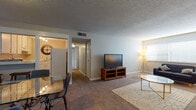 This single-floor, 2-bedroom, 2-bathroom residence offers a practical and comfortable layout designed for everyday living. The generously sized living room features soft carpeting, a textured ceiling, and a large window that allows ample natural light to fill the space, creating a bright and welcoming atmosphere. A dedicated dining area sits adjacent to the living room, complete with a glass-top dining table and a breakfast bar that connects to the kitchen, making it ideal for both casual meals and entertaining.

The kitchen is efficiently designed in an L-shaped layout, featuring white cabinetry, light-toned countertops, a coil-burner range, and a dishwasher, providing all essential appliances in a compact, easy-to-navigate space.

Both bedrooms are carpeted and offer comfortable proportions with neutral wall tones. The primary bedroom provides a serene retreat, while the second bedroom offers flexible use as a guest room or home office. Each bathroom includes a tub-shower combination; one bathroom features wood-look flooring and a clean, tiled surround, adding a touch of warmth to the functional design.

Throughout the residence, neutral color palettes, consistent flooring materials, and thoughtful room flow contribute to a cohesive and livable environment.