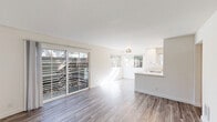 Located at 609 W Junipero St in Santa Barbara, CA, this thoughtfully updated 2-bedroom, 2-bathroom single-story home offers a clean, modern aesthetic throughout. Wood-style luxury flooring flows seamlessly across every room, complementing the crisp white walls and creating a bright, cohesive feel.

The open-concept living and kitchen area serves as the heart of the home. The living room is bathed in natural light thanks to large sliding glass doors that open to an outdoor space, while additional windows invite sunshine from multiple angles. The well-appointed kitchen features white shaker cabinetry reaching to the ceiling, quartz countertops, stainless steel appliances, a matte black faucet, and a breakfast nook area framed by oversized windows with lush tree views.

Both bedrooms are well-proportioned and bright, with the spacious primary bedroom offering a frosted-glass door leading to a private area and a warm wood entry door as a design accent. Each bedroom includes dedicated closet space.

The two bathrooms are finished in a modern style, featuring white subway tile with a dark mosaic accent border, white vanities with quartz countertops, and matte black hardware throughout. The overall ambiance is clean, contemporary, and move-in ready — perfectly suited for comfortable Santa Barbara living.
