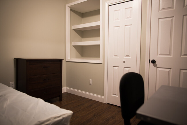 One of our smaller bedrooms, but with ample storage space (see shelves). - 114 Ferris Place